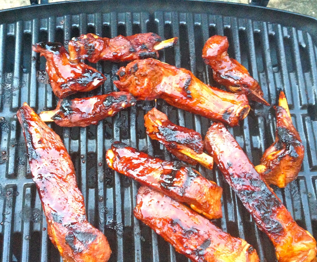 The ribs sizzling on the barbecue