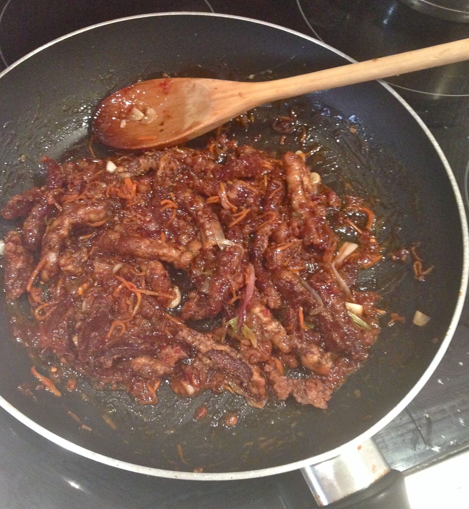 The beef is added to the spicy, sticky sauce